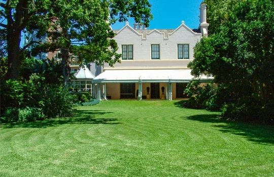 The main garden lawn at Lindesay House with Sydney Harbour views