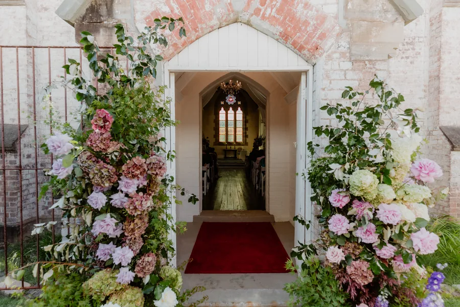 Lords Estate — the chapel doorway framed by a floral arch