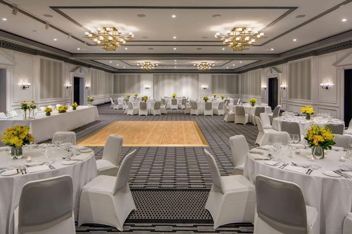 The Grand Ballroom at InterContinental Sydney Double Bay set for a wedding reception with round tables and a parquet dance floor