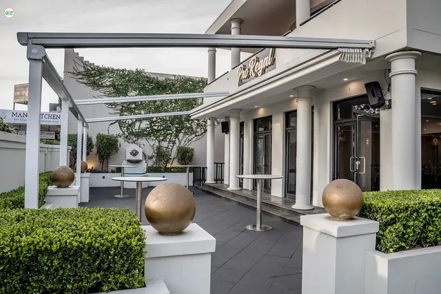 Sunset Court at Pro Regal Pavilion, the outdoor terrace with hedging and cocktail tables
