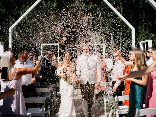 Guests shower the newlyweds with confetti as they leave the open-air chapel