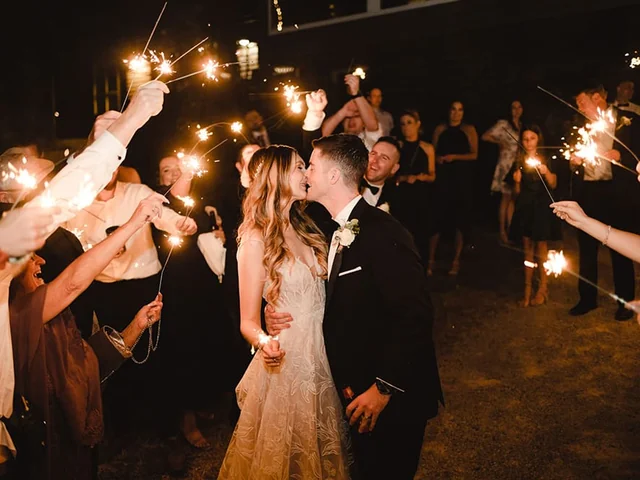 Sparkler send-off for the bride and groom at night