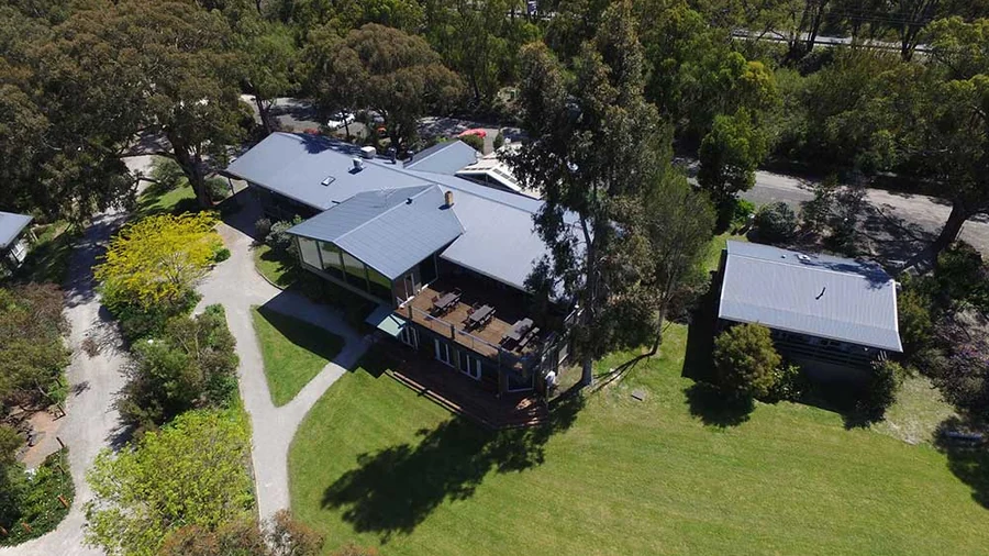 Aerial view of the accommodation wings among the gums at Yarra Valley Estate