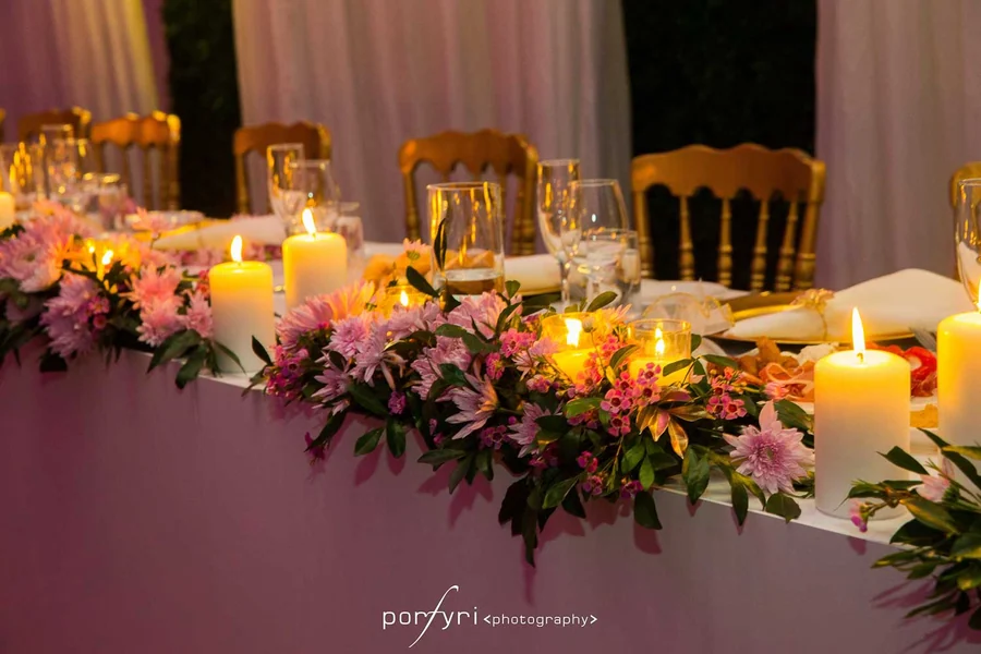 Celebrating In Style &mdash; a bridal table with pink and magenta florals and candlelight