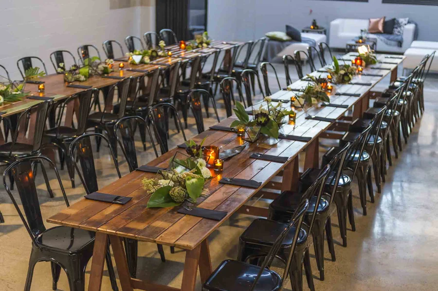 Celebrating In Style &mdash; a long timber table dressed with greenery
