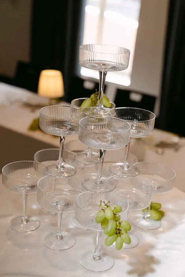 Hitch Perfect — a tower of champagne coupes with grapes and candlelight