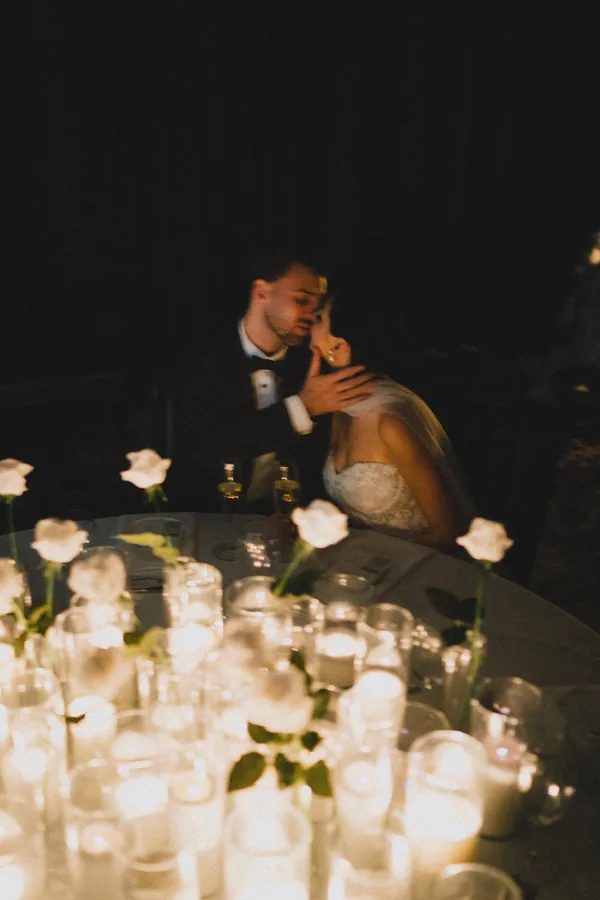 Hitch Perfect — candlelight and white roses across the reception table