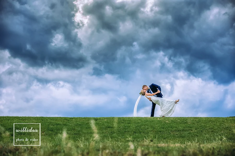 Willidea Studio &mdash; a couple beneath a dramatic storm sky