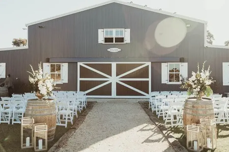 Ceremony set up in front of the custom barn doors at Aberfeldy Barn, the venue&rsquo;s main ceremony location