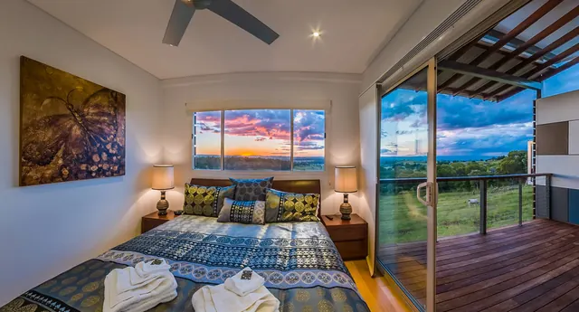 Branell Homestead — a cabin bedroom opening onto the deck