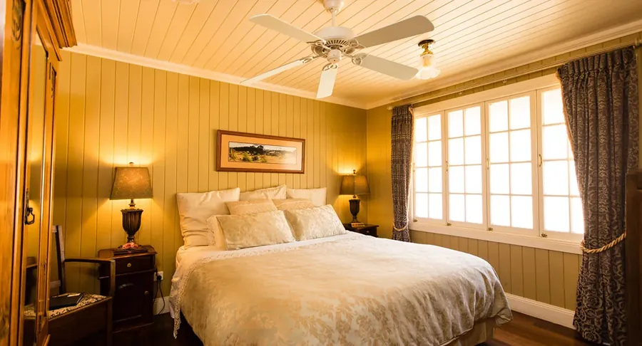 A bedroom inside the homestead at Branell Homestead, where the suites sleep seven adults
