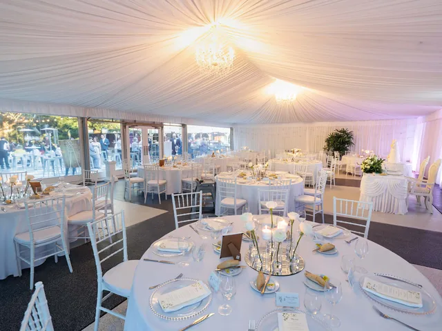 In The Grove — marquee reception styled with round tables