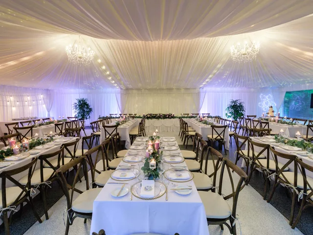In The Grove — marquee reception set with long tables and styling