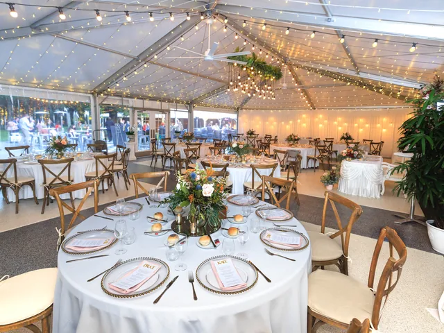 Reception inside the permanent marquee at In The Grove, set with timber chairs and elegant styling