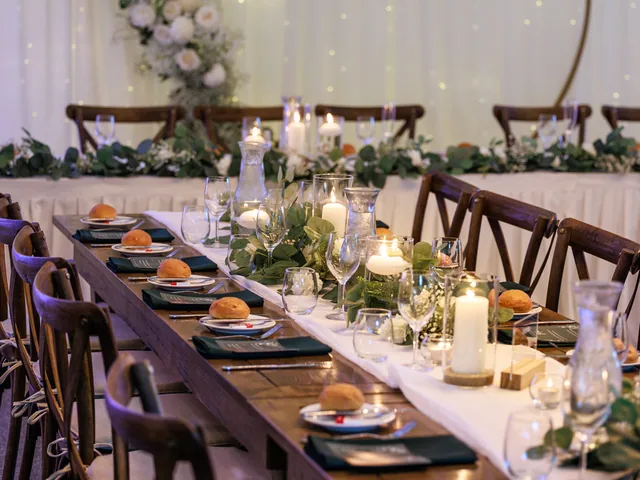 In The Grove — long timber reception tables by candlelight