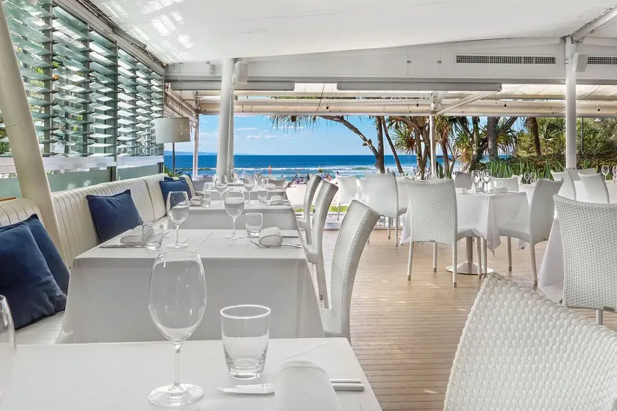 The beachfront restaurant at Sails Noosa, set for an exclusive-use seated wedding reception