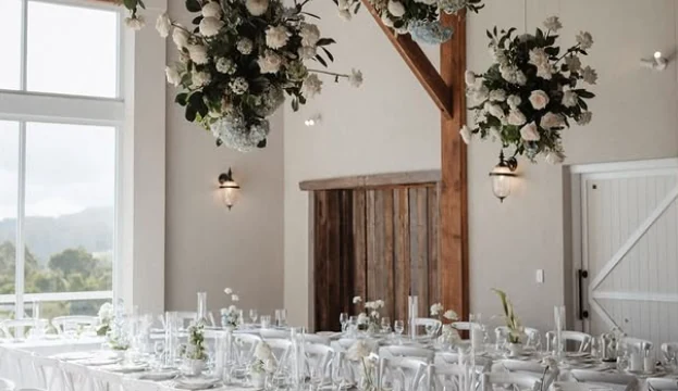Long tables set for a reception in The Barn at The Old Dairy Maleny