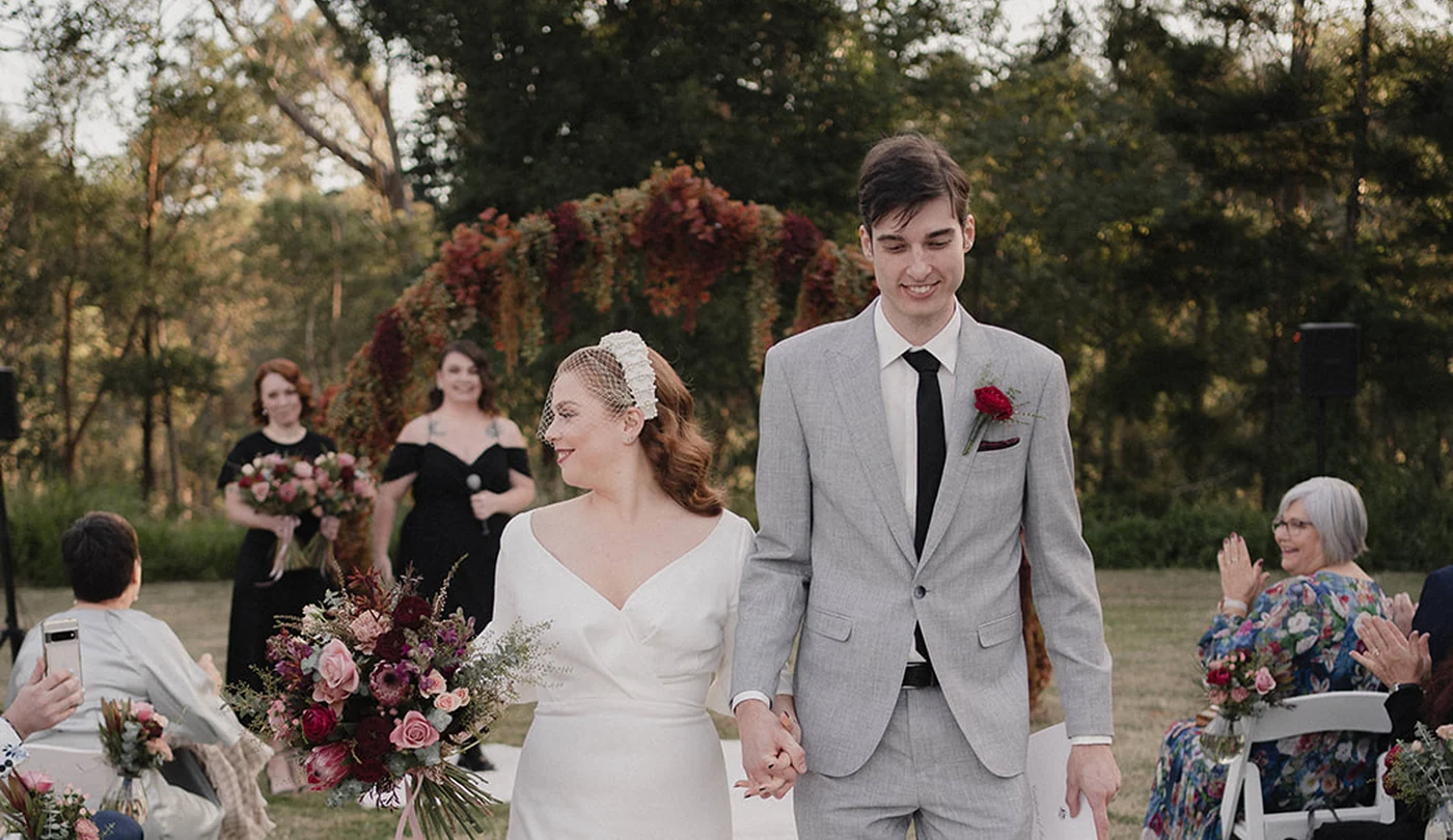 Lawn ceremony with white chairs at Walkabout Creek