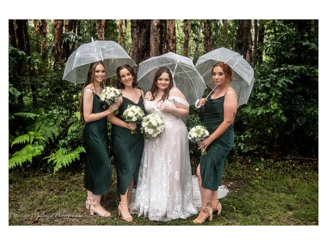 Woodford Gardens — bridesmaids with clear umbrellas on a wet weather day