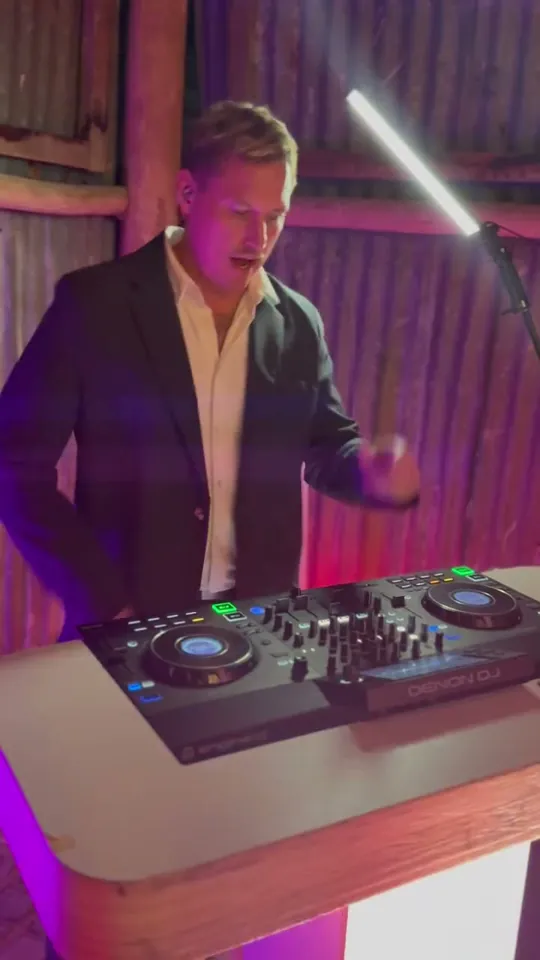 DJ Joe Barrs on the mic and decks at a barn wedding