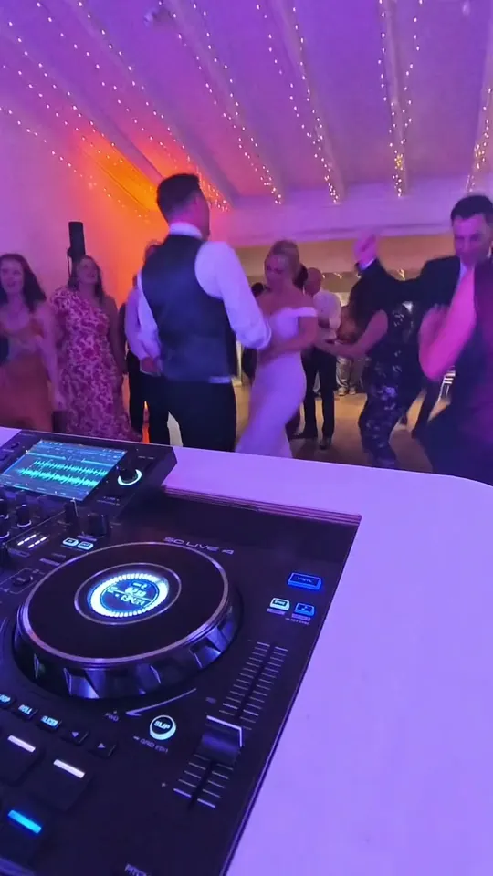 A packed dance floor from behind DJ Joe Barrs’s decks