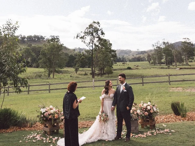 An elopement ceremony on the lawn with the hills of Wallaringa Farm behind