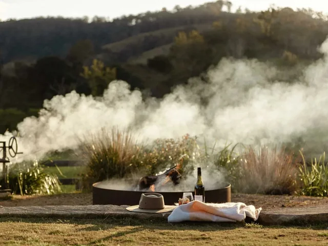 The fire pit at Wallaringa Farm with smoke drifting across the valley