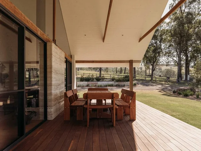 Outdoor dining on the farmhouse deck at Wallaringa Farm, looking over the paddocks