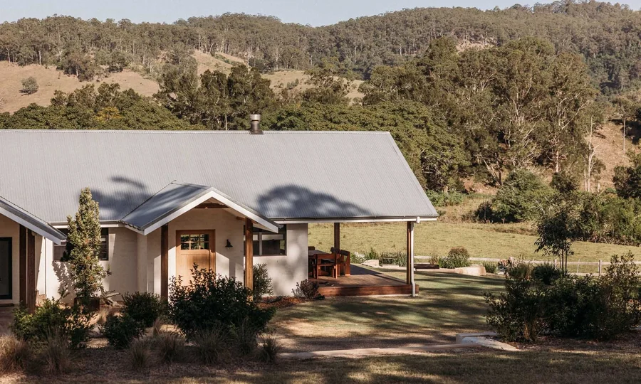 The farmhouse at Wallaringa Farm, set among the paddocks with the hills behind