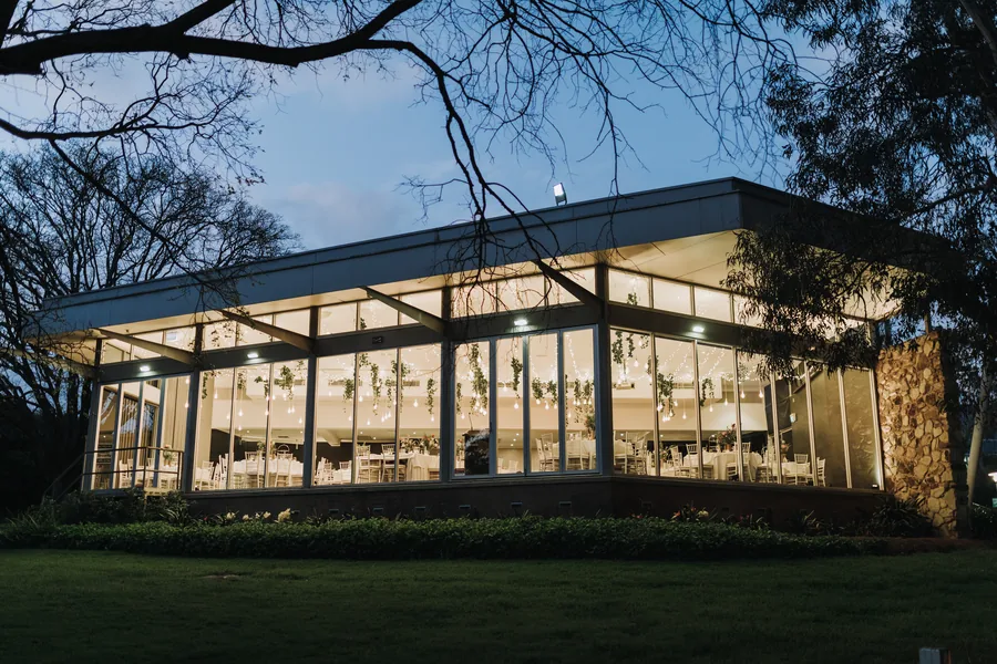 Adelaide Pavilion — the glass pavilion lit up at dusk