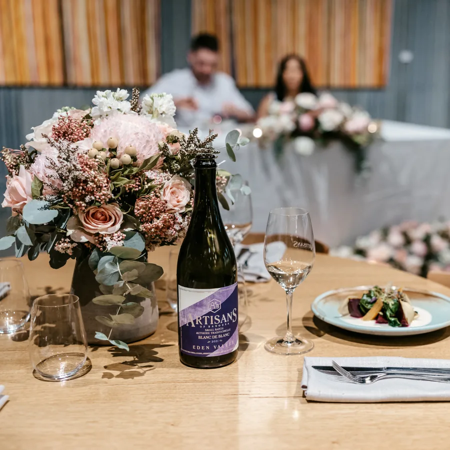 Artisans of Barossa — florals and wine on a dressed table