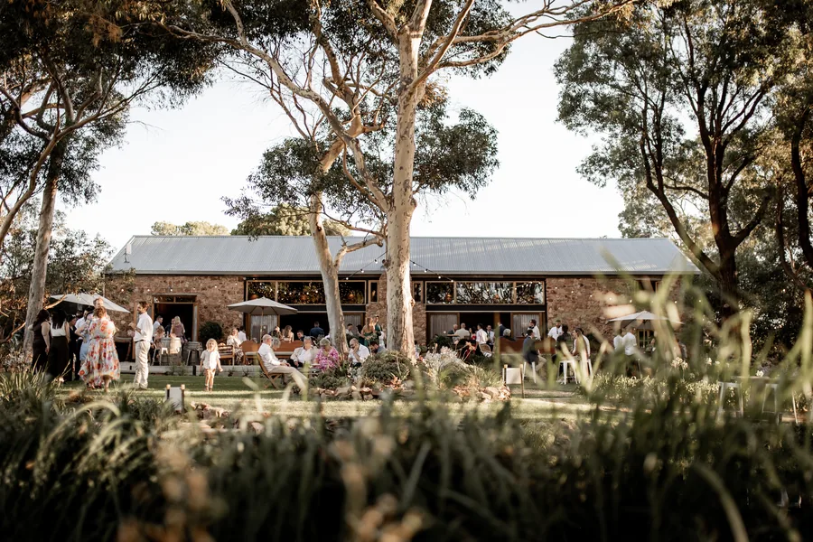 Barn1890 &mdash; the barn and lawn set for a ceremony among the gums