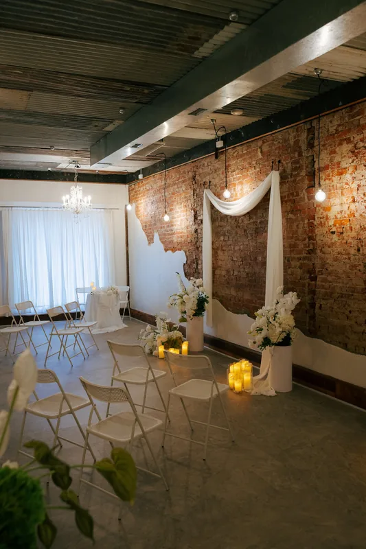 Coco NB &mdash; the room styled for a ceremony with white drapes and candles