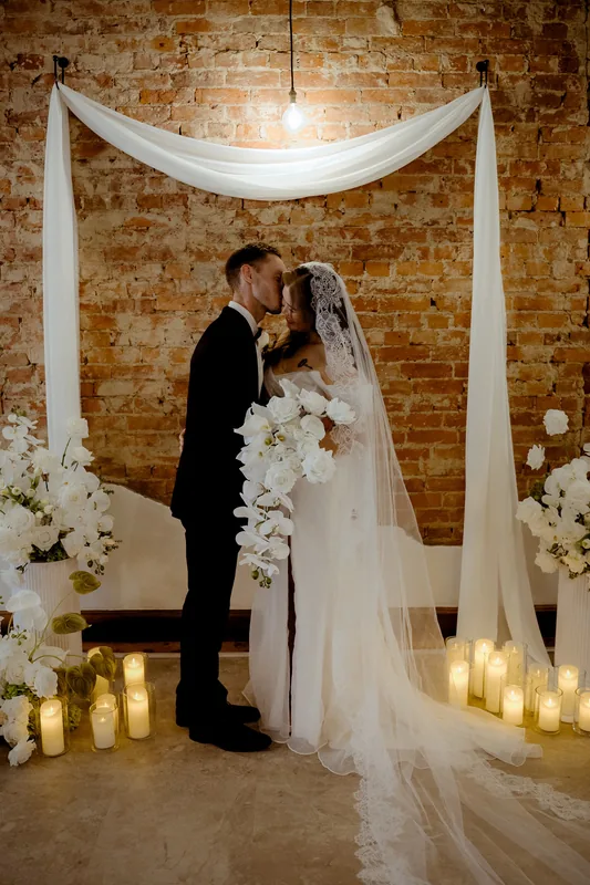 Coco NB &mdash; the couple beneath the drapery, surrounded by candles