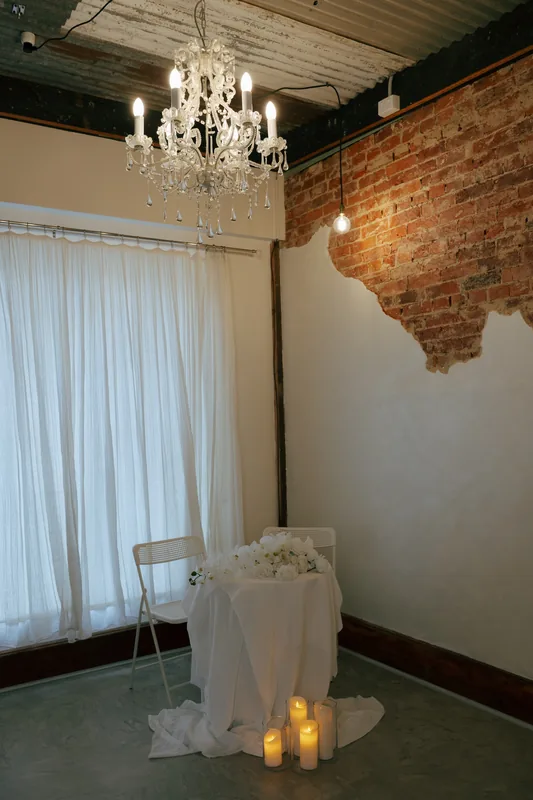 Coco NB &mdash; the chandelier above a candlelit ceremony setting