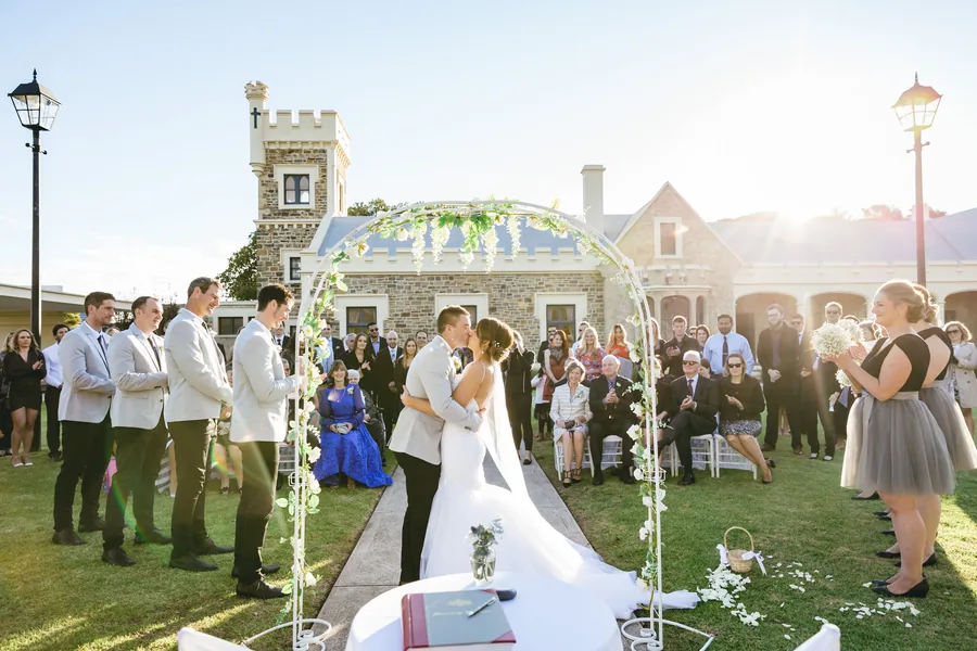 Glanville Hall &mdash; a ceremony on the lawn beneath a floral arbour
