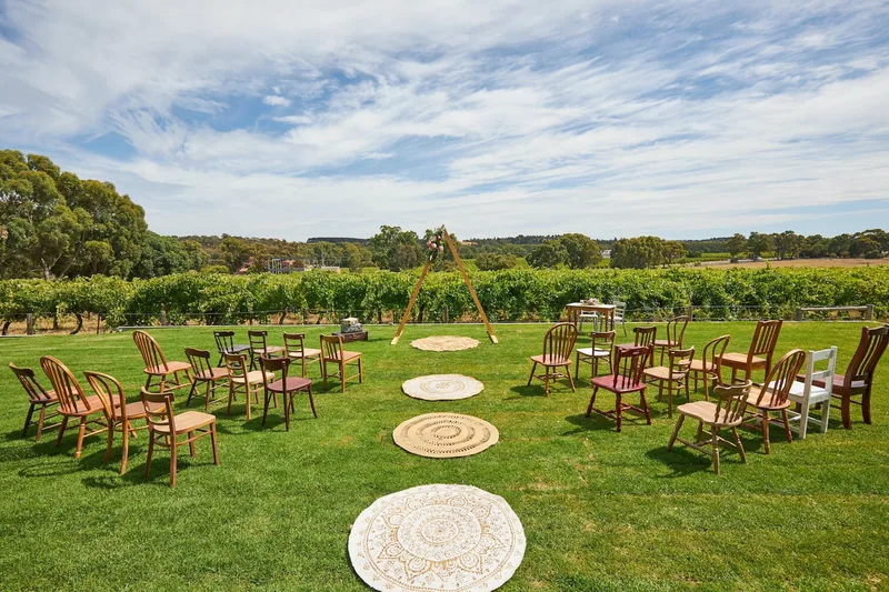 Hastwell & Lightfoot — a ceremony circle on the lawn with the vineyard behind