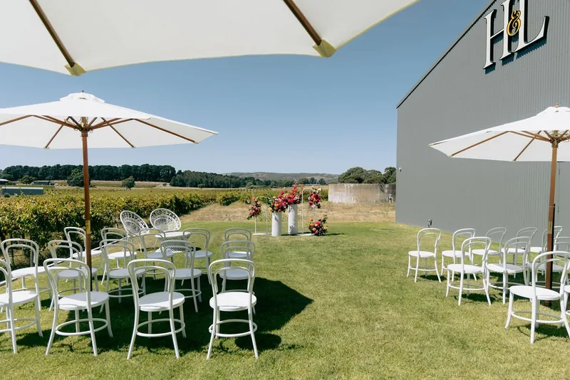 Hastwell & Lightfoot — lawn ceremony seating with umbrellas and vineyard views