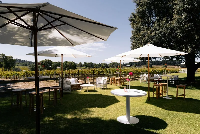 Hastwell & Lightfoot — umbrellas and tables set out on the lawn