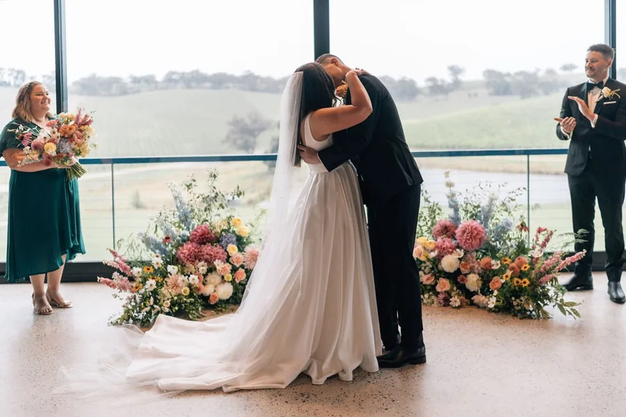 Longview Vineyard — a ceremony framed by florals with the vineyard behind