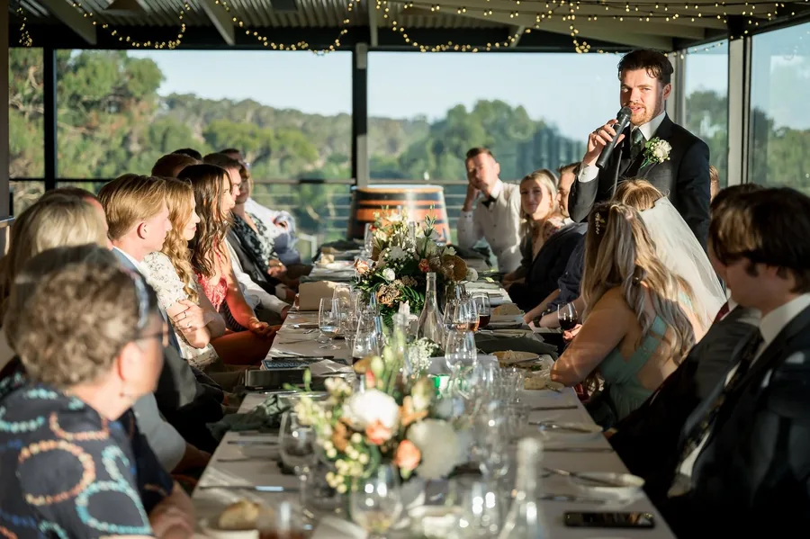 Longview Vineyard &mdash; a long table reception with the vineyard through the windows