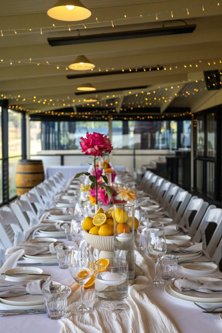Longview Vineyard — a long table dressed with florals under festoon lights