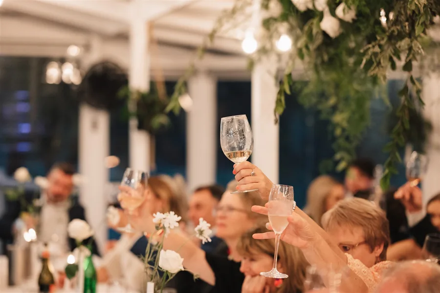 Lost Phoenix Farm &mdash; guests raising a glass under the marquee
