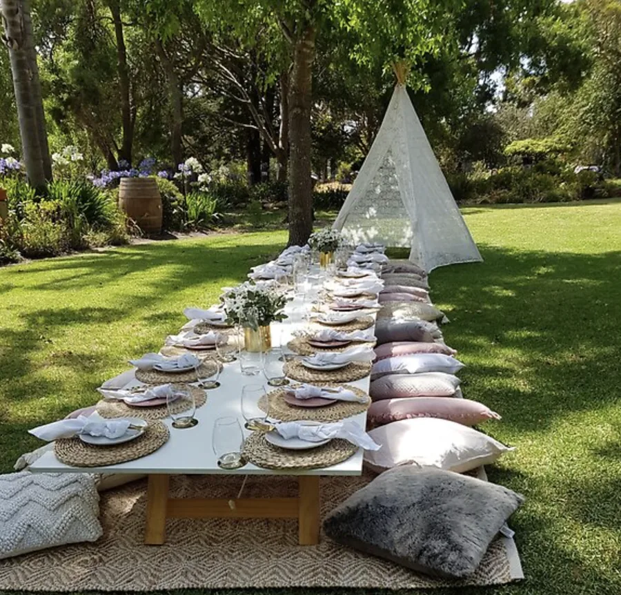 Magpie Springs — a long table with cushions under the trees