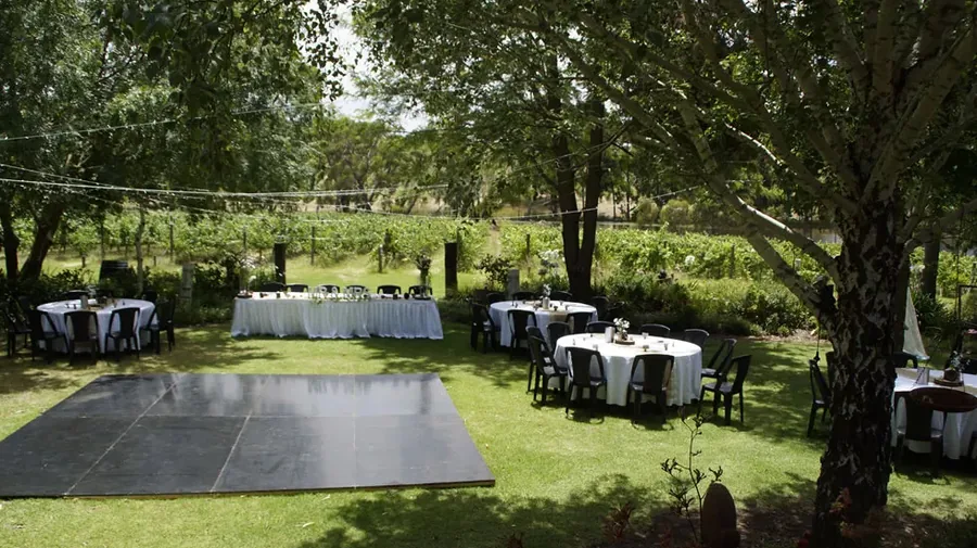 Magpie Springs — the dancefloor and round tables in the garden
