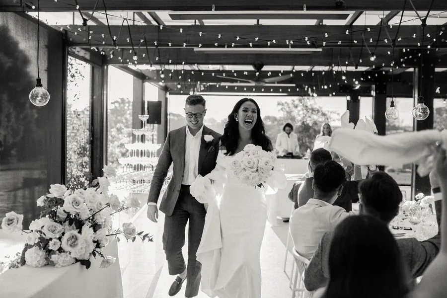 Mitolo &mdash; the couple walking through the reception
