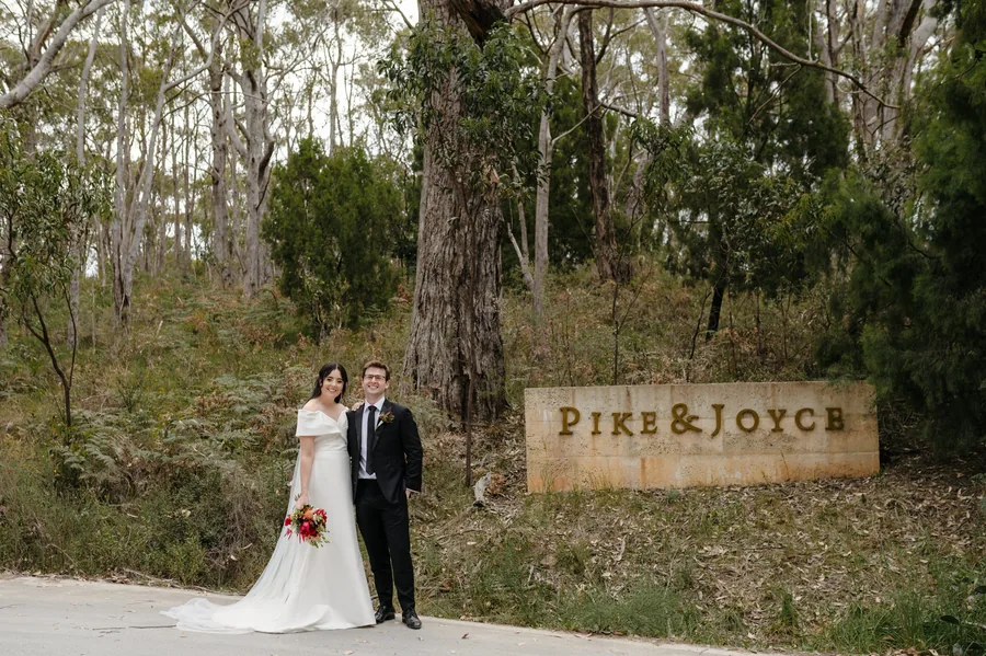 Pike & Joyce Wines &mdash; the couple at the Pike and Joyce sign