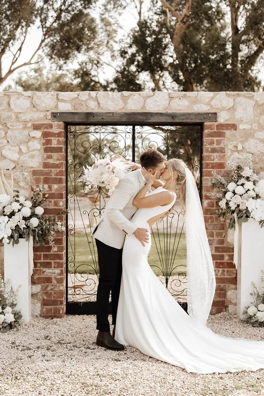 Woodburn Homestead &mdash; the open-air chapel doorway dressed with florals