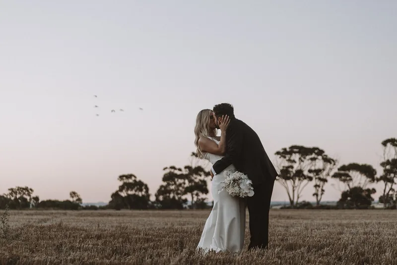 Woodburn Homestead &mdash; the couple at sunset beyond the homestead