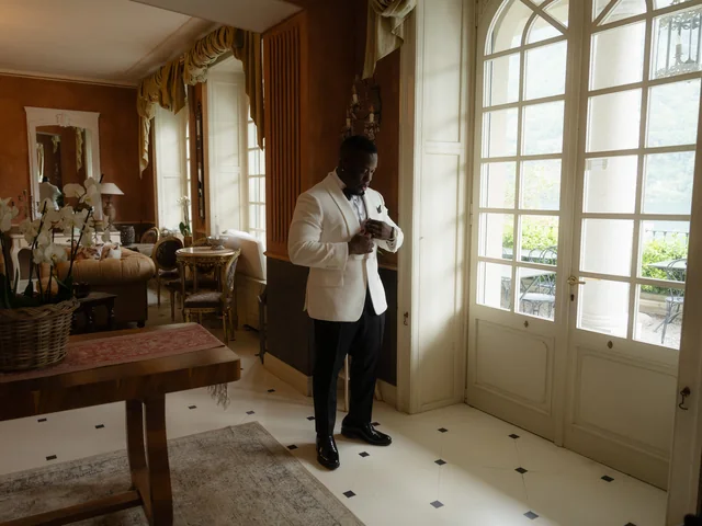 Groom dressing in his LaMilago white dinner jacket on the wedding morning